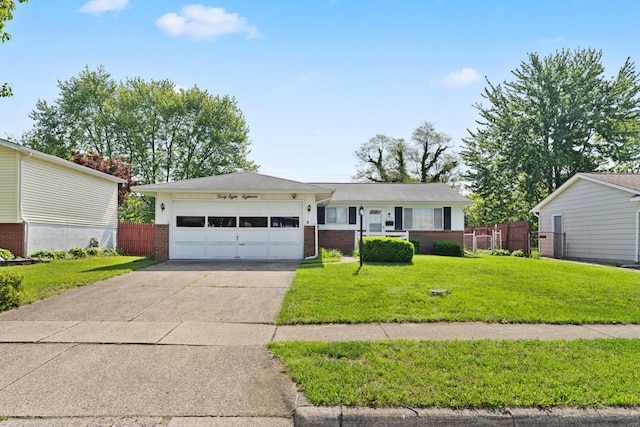 4818 Manitoba Rd, Columbus, OH 43229 - view of front facade with brick siding, an attached garage, and driveway