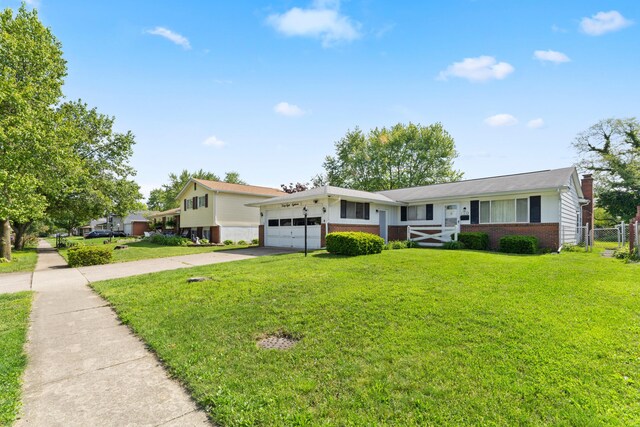 4818 Manitoba Rd, Columbus, OH 43229 - view of front facade featuring brick siding, concrete driveway, a garage, and a chimney