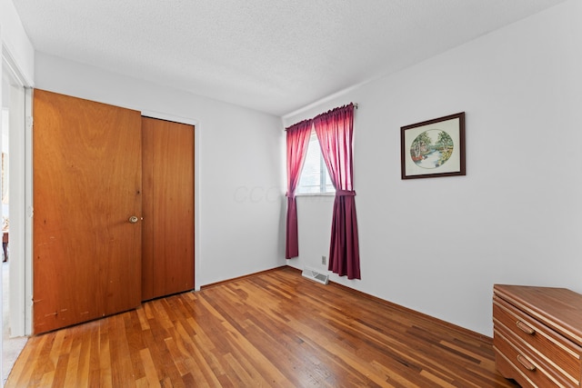 4818 Manitoba Rd, Columbus, OH 43229 - unfurnished bedroom featuring wood finished floors, a closet, and a textured ceiling