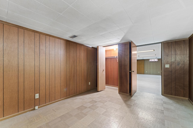 4818 Manitoba Rd, Columbus, OH 43229 - finished basement featuring wood walls, tile patterned floors, and baseboards