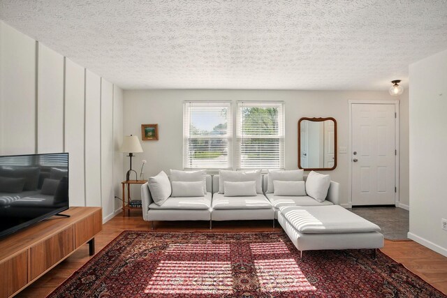 651 Dovalon Pl, Galloway, OH 43119 - living area with wood finished floors, a textured ceiling, and baseboards