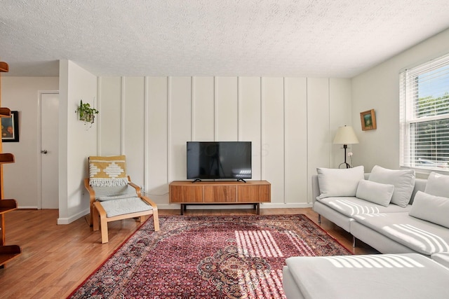 651 Dovalon Pl, Galloway, OH 43119 - living area with wood finished floors, a textured ceiling, and baseboards