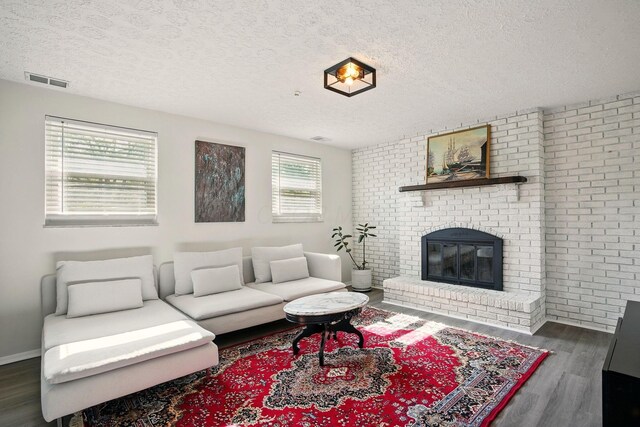 651 Dovalon Pl, Galloway, OH 43119 - living area featuring a textured ceiling, wood finished floors, and a fireplace