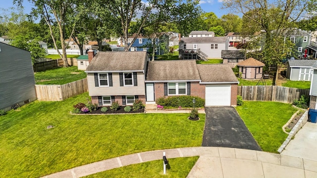 651 Dovalon Pl, Galloway, OH 43119 - view of front of home featuring a residential view, driveway, brick siding, an attached garage, and a shingled roof