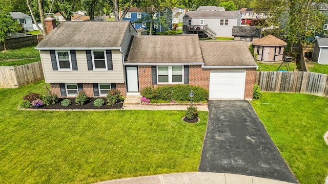 651 Dovalon Pl, Galloway, OH 43119 - view of front of house featuring brick siding, an attached garage, a residential view, driveway, and a shingled roof
