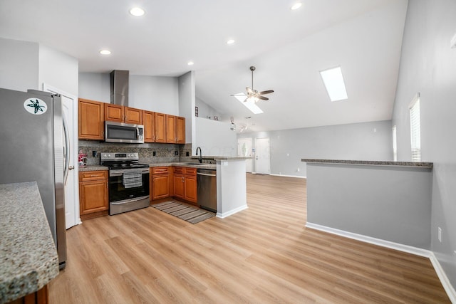 1472 Tall Meadows Dr, Columbus, OH 43223 - kitchen featuring appliances with stainless steel finishes, a sink, a peninsula, high vaulted ceiling, and a ceiling fan