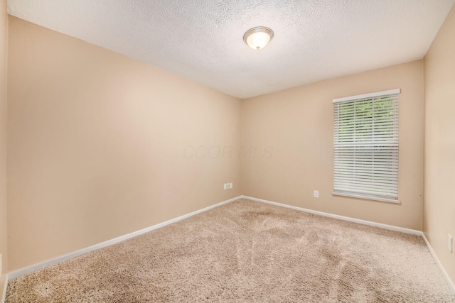 1472 Tall Meadows Dr, Columbus, OH 43223 - spare room featuring carpet, a textured ceiling, and baseboards