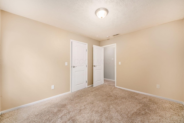 1472 Tall Meadows Dr, Columbus, OH 43223 - carpeted empty room with a textured ceiling and baseboards