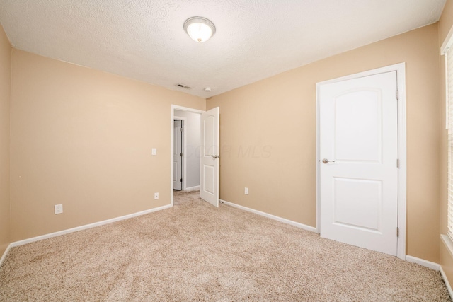 1472 Tall Meadows Dr, Columbus, OH 43223 - unfurnished bedroom featuring carpet flooring, baseboards, and a textured ceiling