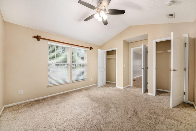 1472 Tall Meadows Dr, Columbus, OH 43223 - unfurnished bedroom featuring multiple closets, carpet floors, lofted ceiling, baseboards, and a ceiling fan