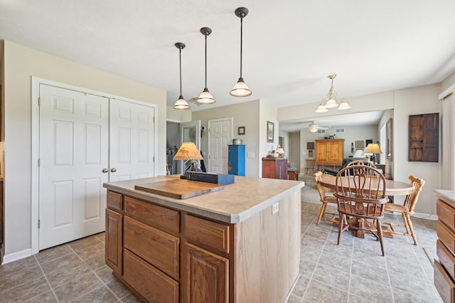 15301 Gandy Eddy Rd, Marysville, OH 43040 - kitchen with light countertops, a ceiling fan, a kitchen island, and hanging light fixtures