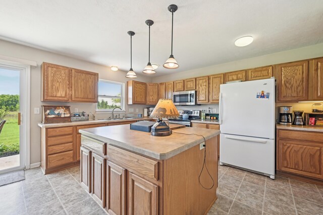 15301 Gandy Eddy Rd, Marysville, OH 43040 - kitchen featuring stainless steel appliances, light countertops, a kitchen island, hanging light fixtures, and brown cabinetry