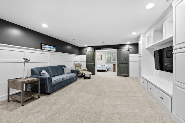 5568 Lexington Dr, Hilliard, OH 43026 - living room with light colored carpet, a barn door, a decorative wall, recessed lighting, and a wainscoted wall