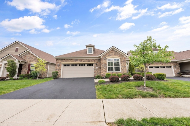 5568 Lexington Dr, Hilliard, OH 43026 - view of front facade featuring driveway, stone siding, and a garage