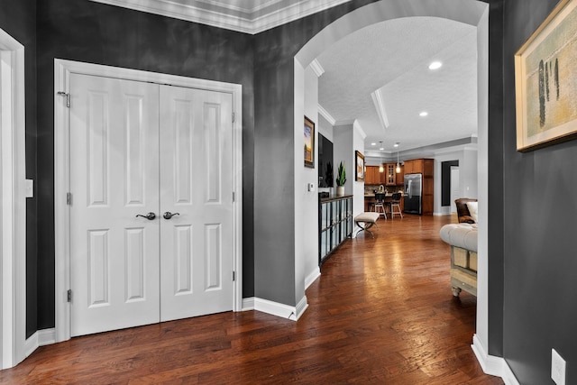 5568 Lexington Dr, Hilliard, OH 43026 - hallway with arched walkways, ornamental molding, wood finished floors, a textured ceiling, and recessed lighting