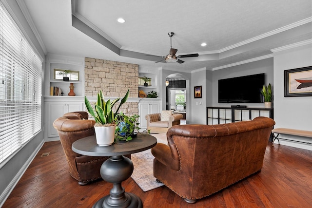 5568 Lexington Dr, Hilliard, OH 43026 - living area with arched walkways, wood finished floors, a ceiling fan, crown molding, and a raised ceiling