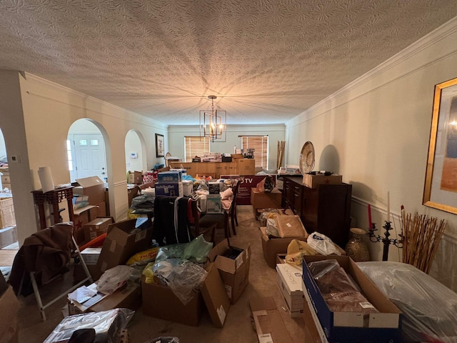 310 Abbey Ave, Lithopolis, OH 43136 - dining area featuring ornamental molding, arched walkways, a textured ceiling, and a chandelier