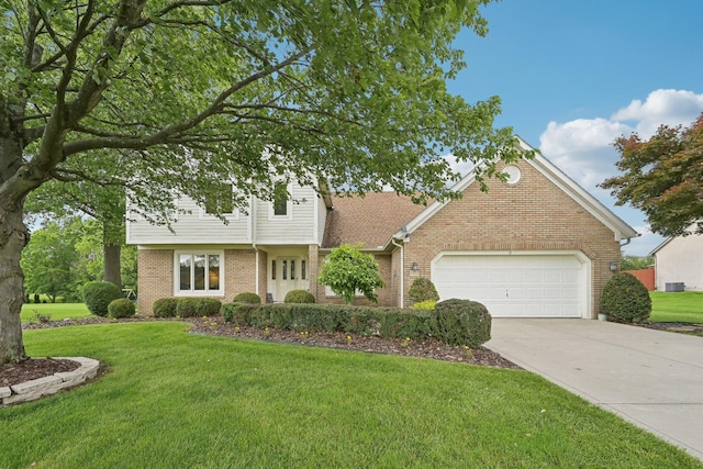 8628 N Spring Ct, Pickerington, OH 43147 - view of front of property with brick siding, driveway, a garage, and a front yard