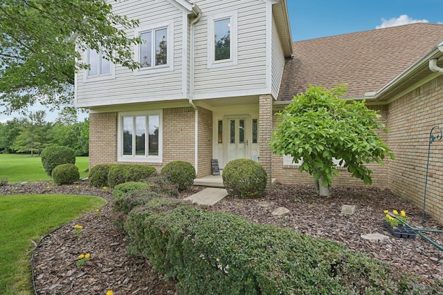 8628 N Spring Ct, Pickerington, OH 43147 - view of front of house featuring brick siding, a front lawn, and a shingled roof