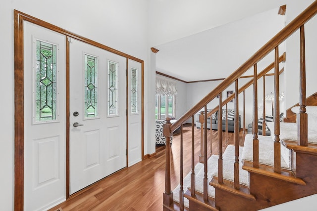 8628 N Spring Ct, Pickerington, OH 43147 - entryway with wood finished floors, stairway, ornamental molding, and baseboards