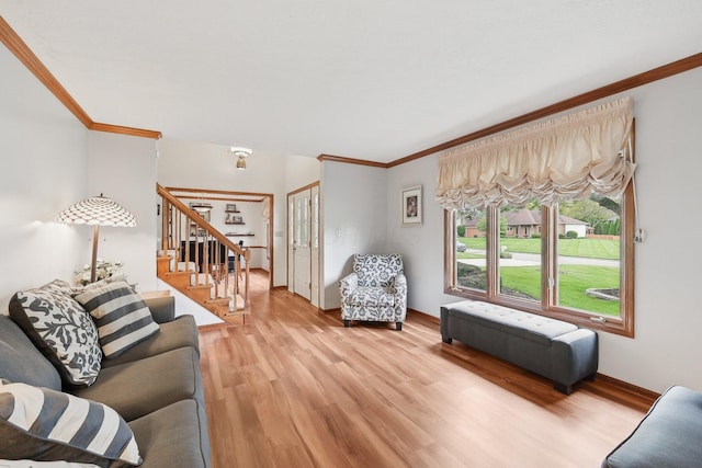 8628 N Spring Ct, Pickerington, OH 43147 - living room with ornamental molding, stairway, light wood-style floors, and baseboards