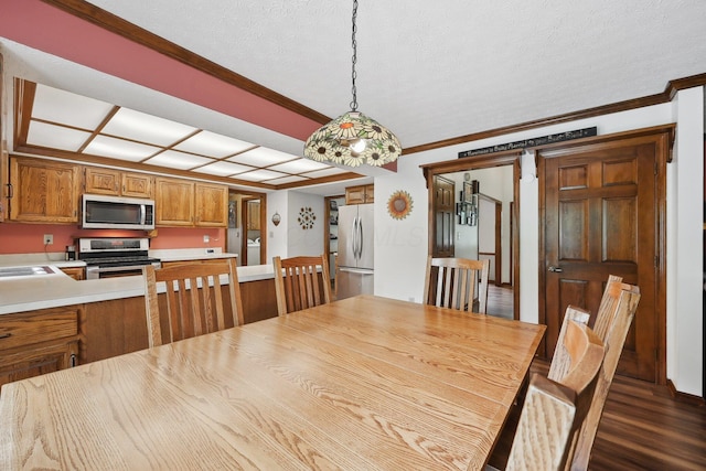 8628 N Spring Ct, Pickerington, OH 43147 - dining space featuring ornamental molding, dark wood-type flooring, and a textured ceiling
