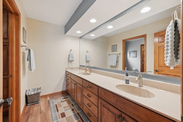 8628 N Spring Ct, Pickerington, OH 43147 - full bathroom featuring double vanity, recessed lighting, baseboards, toilet, and wood finished floors