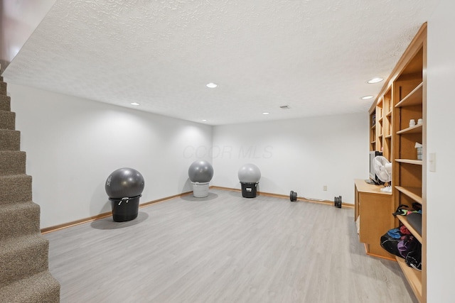 8628 N Spring Ct, Pickerington, OH 43147 - exercise area featuring light wood finished floors, baseboards, a textured ceiling, and recessed lighting