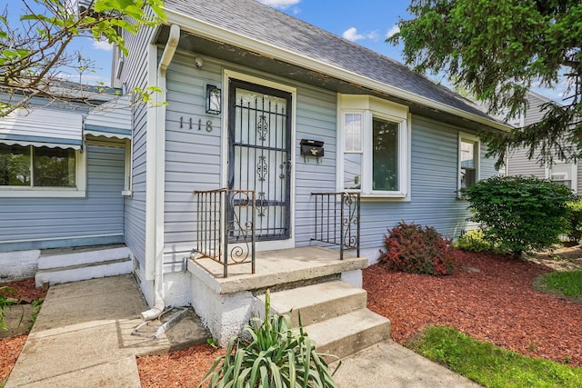 1118 E 26th Ave, Columbus, OH 43211 - doorway to property featuring roof with shingles
