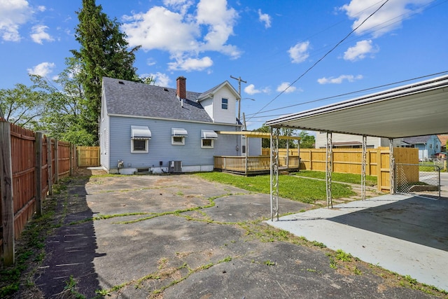 1118 E 26th Ave, Columbus, OH 43211 - back of house featuring a fenced backyard, roof with shingles, a deck, central air condition unit, and a patio