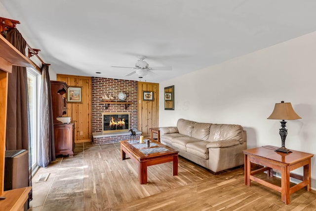 3350 Cameron St, Grove City, OH 43123 - living area with wood finished floors, ceiling fan, a brick fireplace, wood walls, and baseboards