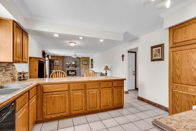3350 Cameron St, Grove City, OH 43123 - kitchen with dishwasher, a peninsula, a fireplace, brown cabinets, and light countertops
