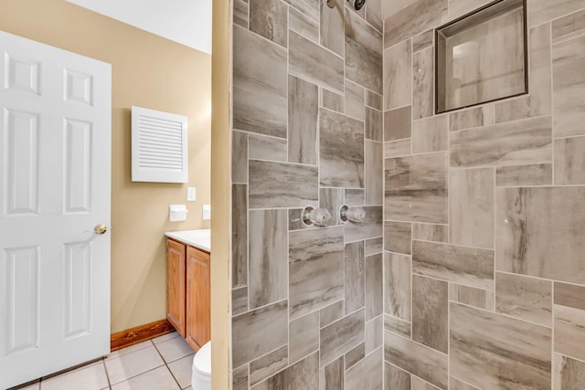 3350 Cameron St, Grove City, OH 43123 - full bathroom featuring a tile shower, vanity, toilet, tile patterned flooring, and baseboards