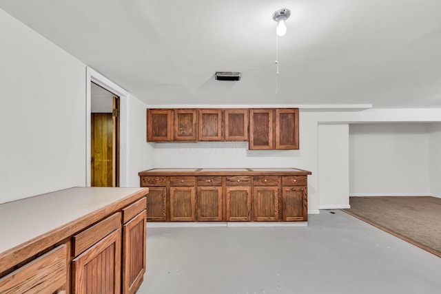 3350 Cameron St, Grove City, OH 43123 - kitchen with finished concrete floors, light countertops, and brown cabinets