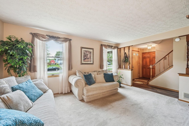 8177 Maugham Dr, Reynoldsburg, OH 43068 - living area featuring carpet flooring, a textured ceiling, and stairs