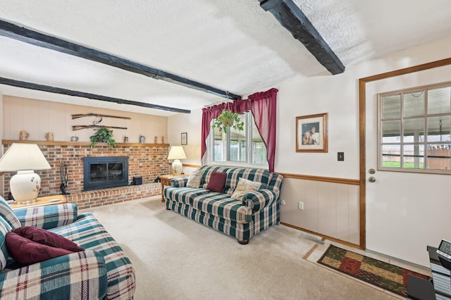 8177 Maugham Dr, Reynoldsburg, OH 43068 - living area featuring plenty of natural light, beam ceiling, carpet, a textured ceiling, and a fireplace
