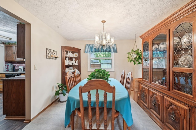 8177 Maugham Dr, Reynoldsburg, OH 43068 - dining space with a chandelier, a textured ceiling, carpet flooring, and baseboards