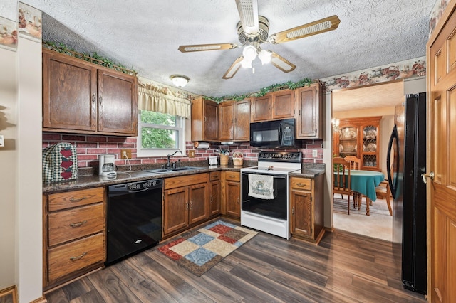 8177 Maugham Dr, Reynoldsburg, OH 43068 - kitchen featuring black appliances, a sink, dark countertops, a textured ceiling, and ceiling fan