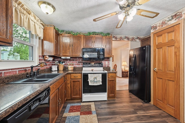 8177 Maugham Dr, Reynoldsburg, OH 43068 - kitchen with black appliances, a sink, dark countertops, brown cabinets, and a textured ceiling