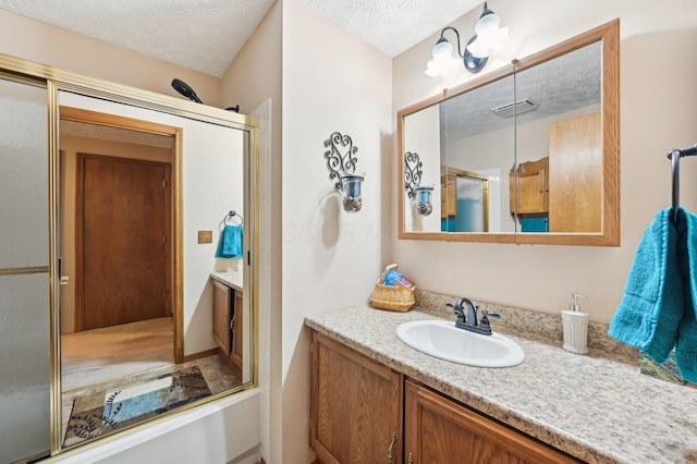 8177 Maugham Dr, Reynoldsburg, OH 43068 - bathroom featuring vanity, a shower with shower door, and a textured ceiling