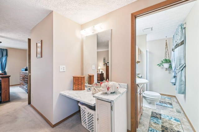 8177 Maugham Dr, Reynoldsburg, OH 43068 - bathroom featuring a textured ceiling, toilet, vanity, and baseboards