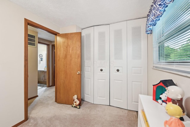 8177 Maugham Dr, Reynoldsburg, OH 43068 - bedroom with light carpet, a textured ceiling, and a closet