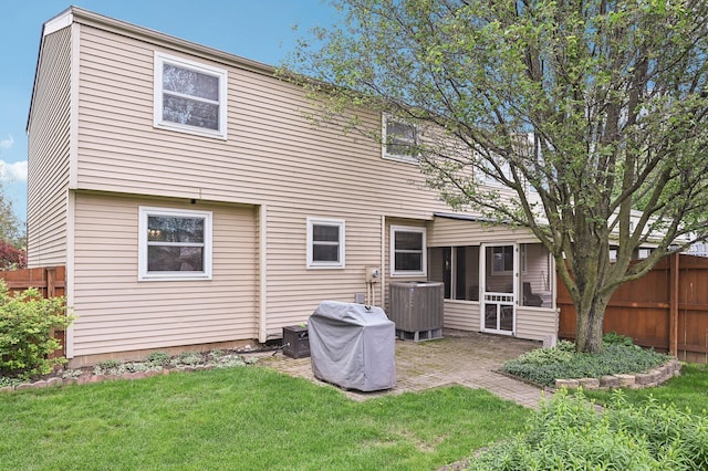 8177 Maugham Dr, Reynoldsburg, OH 43068 - rear view of property featuring central air condition unit, a patio area, and a sunroom