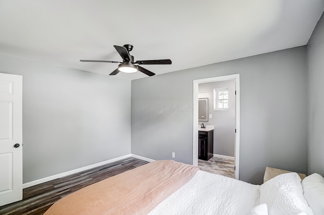12323 Ringer Ln, Leesburg, OH 45135 - bedroom featuring wood finished floors, baseboards, a sink, and ensuite bathroom