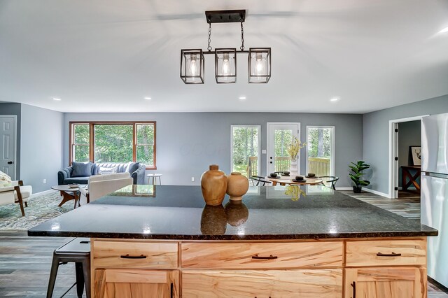 12323 Ringer Ln, Leesburg, OH 45135 - kitchen with baseboards, freestanding refrigerator, open floor plan, wood finished floors, and recessed lighting