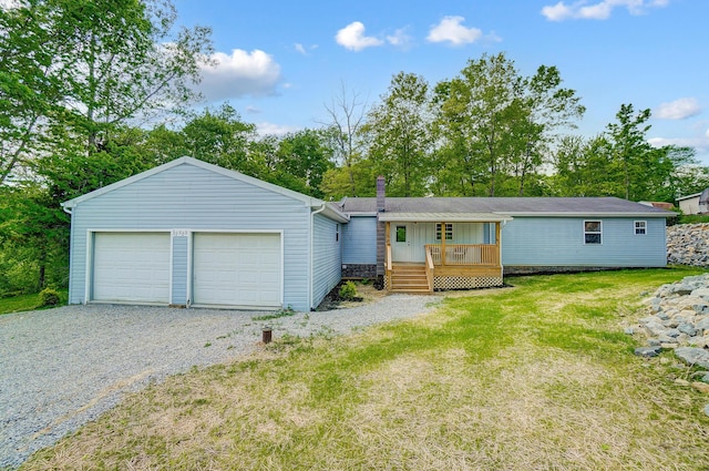 12323 Ringer Ln, Leesburg, OH 45135 - view of front of home with a garage, a front lawn, board and batten siding, and gravel driveway