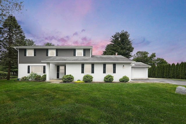 11831 Woodbridge Ln NW, Baltimore, OH 43105 - traditional home featuring concrete driveway, a lawn, a garage, and brick siding