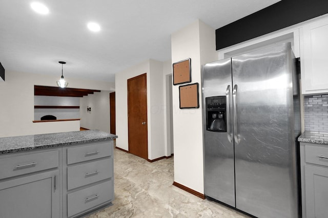 11831 Woodbridge Ln NW, Baltimore, OH 43105 - kitchen with stainless steel fridge with ice dispenser, gray cabinets, dark stone counters, decorative backsplash, and decorative light fixtures