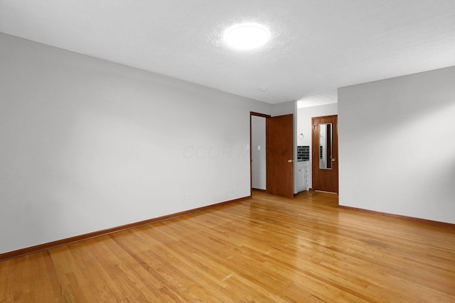 11831 Woodbridge Ln NW, Baltimore, OH 43105 - empty room with baseboards and light wood-style flooring