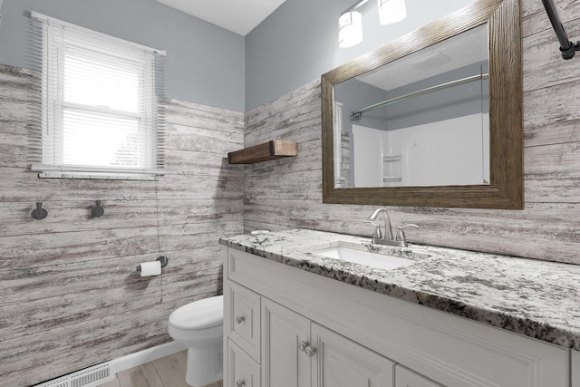 11831 Woodbridge Ln NW, Baltimore, OH 43105 - bathroom with vanity, toilet, a shower, and wood finished floors